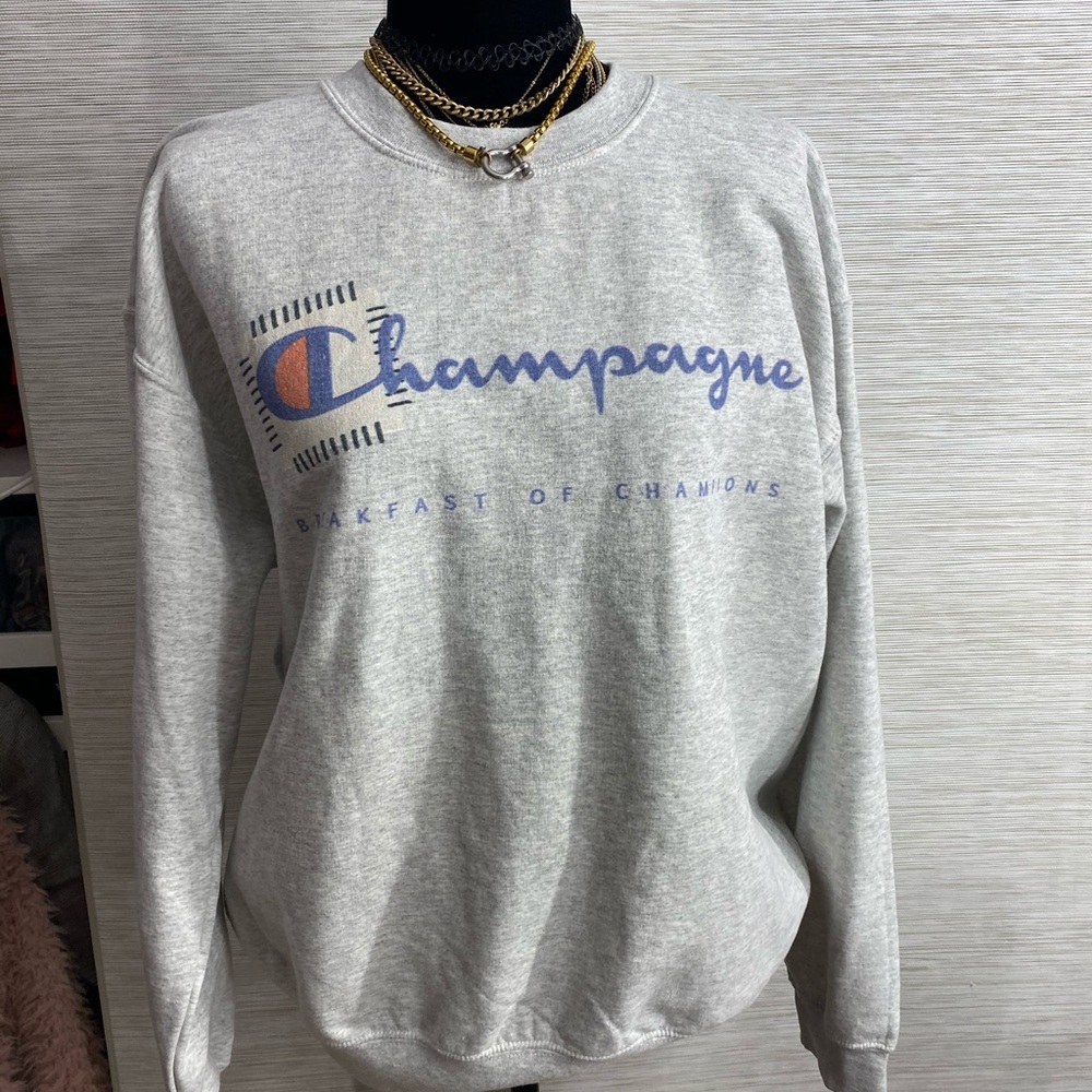 Champagne sweater in the style of “champion” logo